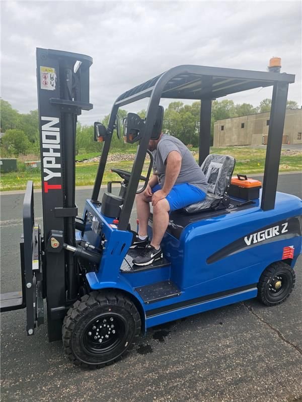 Blue TYPHON VIGOR electric forklift handling materials outdoors